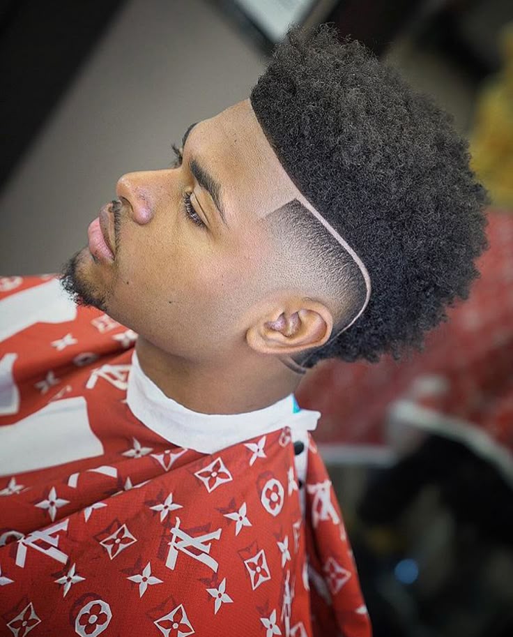 Client in the barber cape with a freshly shaped cut and line-up