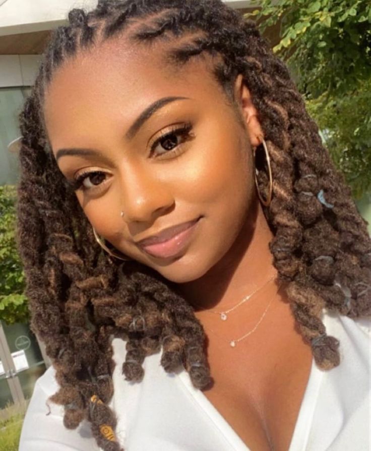 Shoulder-length locs twisted and finished with curled ends