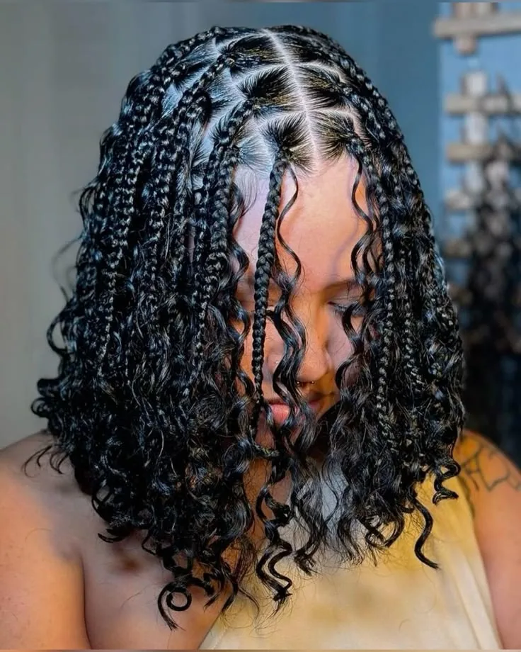 Knotless bob-length braids with loose curled ends framing the face