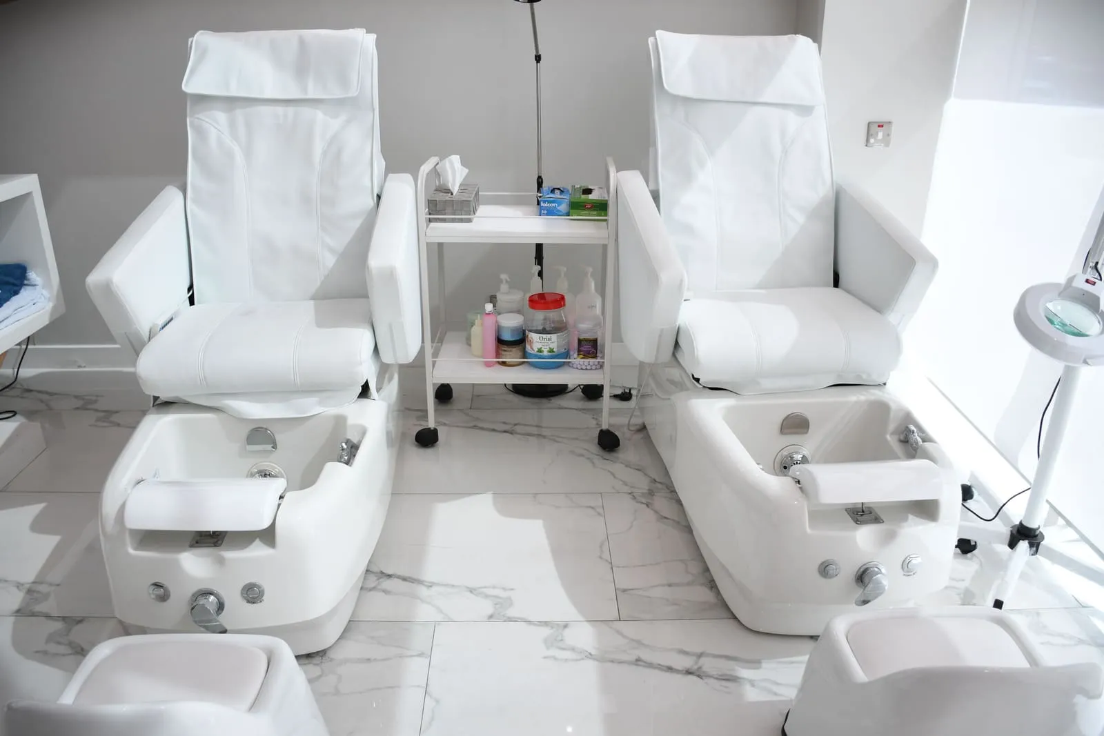 The salon's treatment room, with pedicure stations and marble floors
