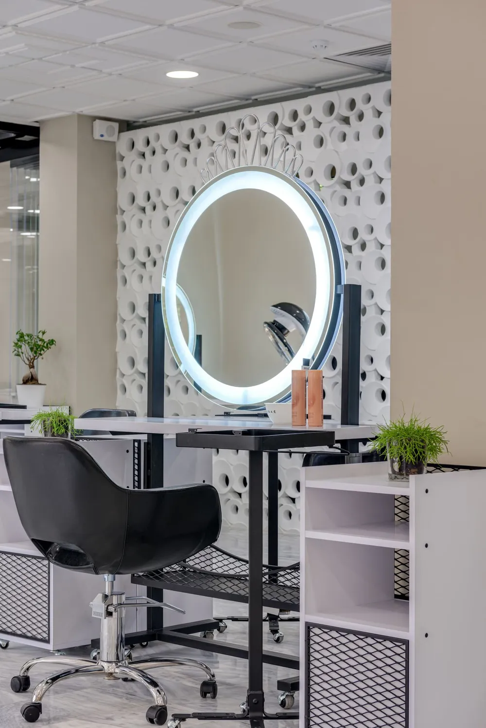 A styling station with a backlit round mirror